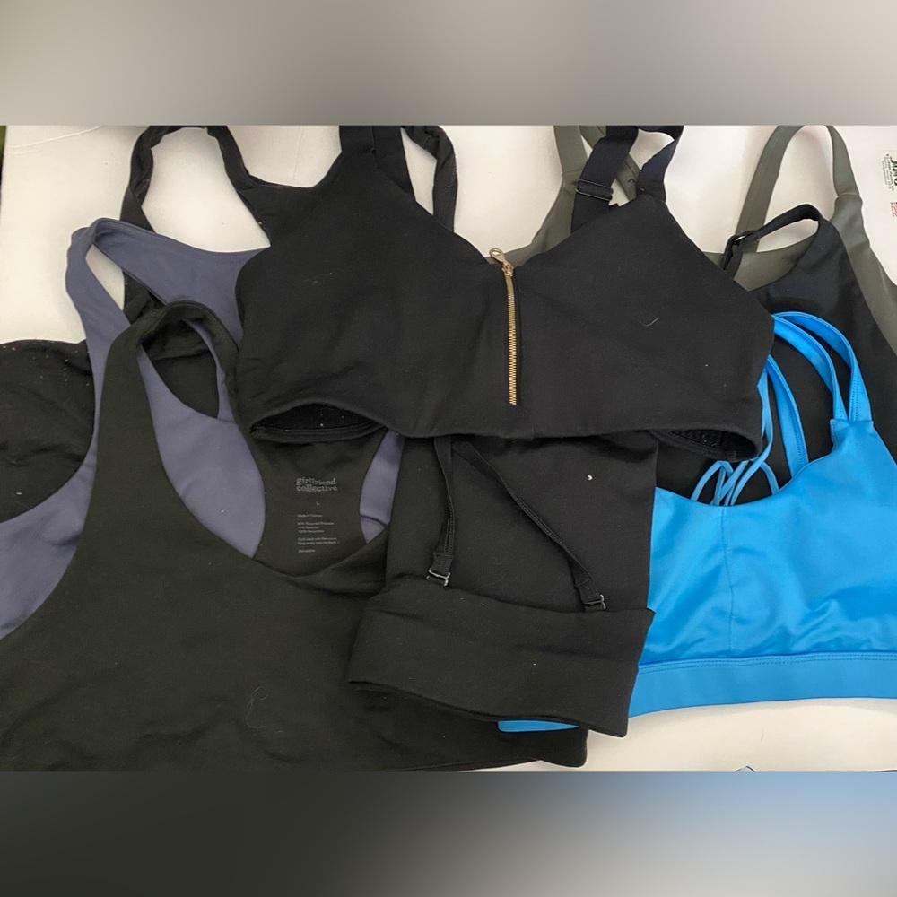7 Girlfriend Collective sports bras and 1 champion sports bra. All size Large